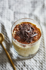 Delicious tiramisu with topping of cacao powder and shaved chocolate