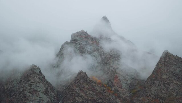 4K shot of clouds above the mountain peaks during the storm at Jispa in Lahaul Spiti district at Himachal Pradesh in India. Clouds covers the peaks of the mountains. Natural background.	
