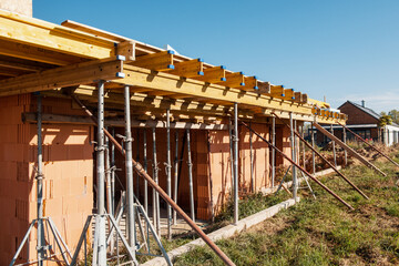 The supports of monolithic floor formwork at a construction site. Telescopic props for concrete flooring. © marco