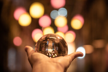 Hand with a crystal ball at night