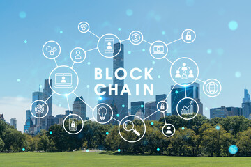 Fototapeta premium Green lawn at Central Park and Midtown Manhattan skyline skyscrapers at day time, New York City, USA. Decentralized economy. Blockchain, cryptography and cryptocurrency concept, hologram