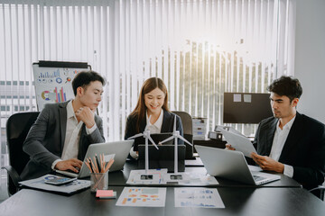 Asian business people using tablet for working technology and business,  Renewable energy-based green businesses and global warming. Reduce CO2 emission.
