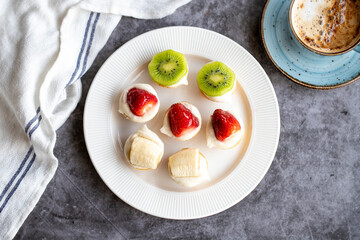 Tartlet dessert on a dark background. Traditional french cuisine delicacies. Small fruit desserts. Top view