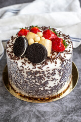 Cake with fruit and biscuit pieces on a dark background. close up