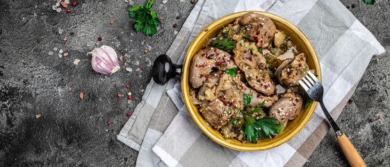 Raw chicken stomach, Traditional Korean spicy chicken gizzard with onions, garlic, chili and sesame on a gray background, place for text, top view
