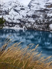 OESCHINEN LAKE - SWITZERLAND - NOVEMBER 2022 - Fantastic panorama of Oeschinen lake, Switzerland. Picturesque autumn landscape in the Swiss alps. The beauty of nature background.