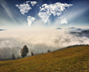 clouds in the form of a map of the world over the mountains. autumn dawn in the Carpathians. Travel and landscape concept 