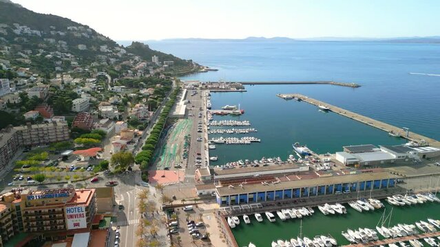 Flight over the marina and fishermen images of green nets Aerial images of the city of Roses on the Costa Brava in Girona Mediterranean beach region of Alto Ampurdán