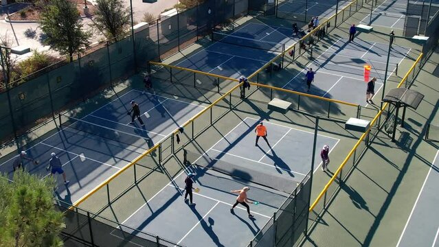 People playing pickleball - high angle aerial view of city park courts