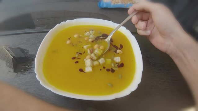 POV First Person Eating Orange Pumpkin Soup Outside