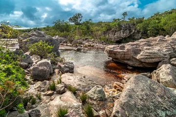Fototapeten Wald Fluss A mountain river flows through rocks in South America  © edojob
