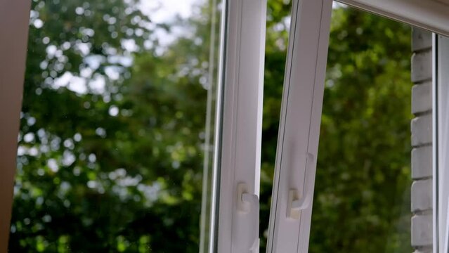 manual open white pvc plastic window at home for ventilation in good weather.