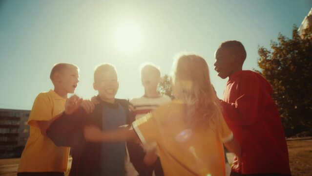 Neighborhood Kids Playing Soccer In The Backyard. Young Football Player Scoring A Goal. Boys And Girls Hug, Celebrate The Victory. Concept Of Outdoors Sports, Childhood And Friendship.