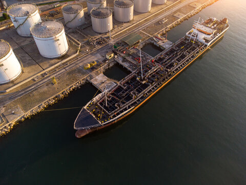 Aerial view of oil ship tanker and lpg ship at industrial port at sunset