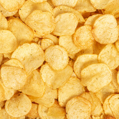 Crispy fresh potato chips, snacks background. Top view, flat lay.