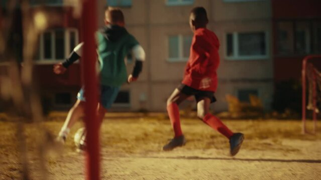 Young Caucasian Boy Playing Soccer with Diverse Friends. Multiethnic Kids Enjoying a Game of Football in the Neighborhood. Player Celebrating the Goal with Teammates.