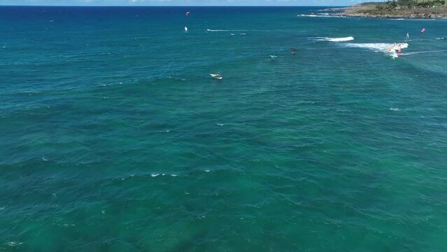 Wing foilers carving waves as wind surfers have close call on Hookipa reef break