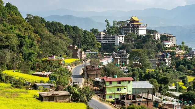 A time-lapse view of the Neydo Tashi Choling Monastery in the small town of Dakshinkali in Nepal surrounded with mustard fields.