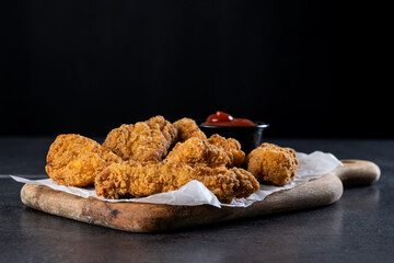Crispy Kentucky fried chicken on black slate background