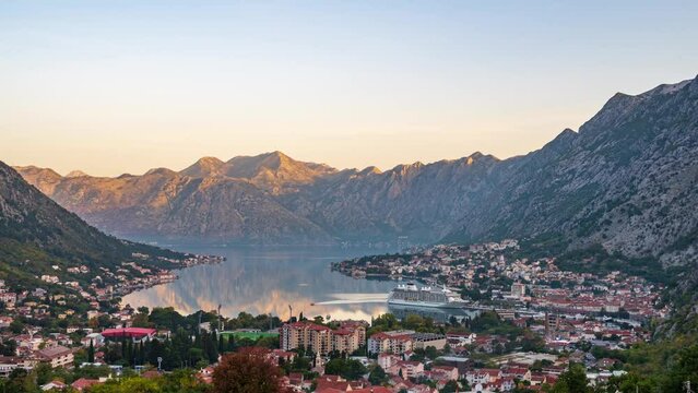 Amazing time lapse video with morning view of picturesque Kotor bay with old town and cruise ship at the port.