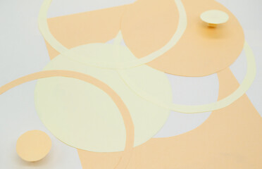 Abstract background with 3D paper elements in beige, orange colors resembles female forms - chest, abdomen. Backdrop advertising products, copy space