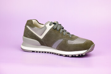 Sneakers for everyday use. Sneaker with suede and fabric parts on a pale lilac background....
