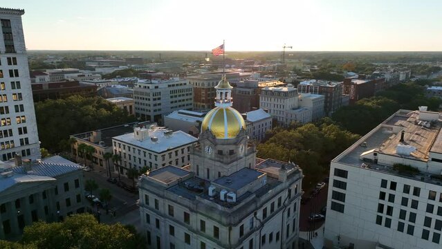 Aerial orbit of City Hall in Savannah Georgia at golden hour sunset.