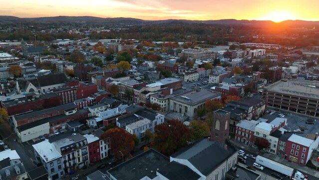 Downtown historic old buildings in USA. America city at sunset. Aerial orbit of residential and business district.