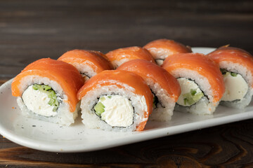Sushi rolls philadelphia. Sushi roll with rice, cream chees, red fish, salmon. Sushi menu. Japanese kitchen, restaurant.