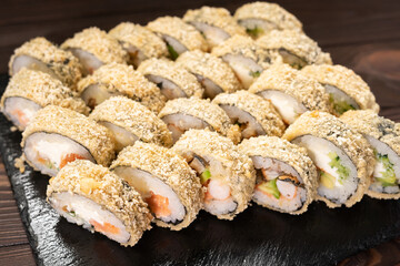 Hot fried sushi roll with salmon and eel. Sushi menu concept. Japanese food. Hot fried sushi roll tempura