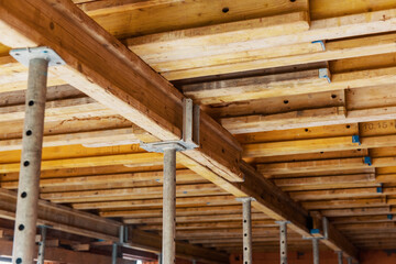The supports of monolithic floor formwork at a construction site. Telescopic props for concrete flooring.