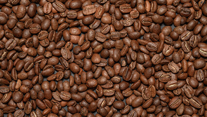 Texture of roasted aromatic brown coffee beans.
