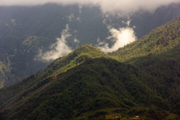 Green forested hills around the town of Sa Pa in the highlands of North Vietnam.