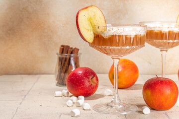 Apple cider marshmallow cocktail, tasty apple juice martini with autumn spices and marshmallows,...