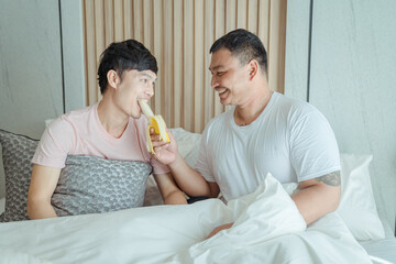 Young asian homosexual couple having breakfast in bed together ,LGBT gay couple relationship...