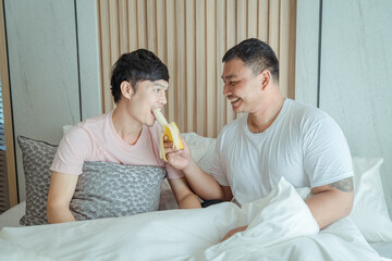 Young asian homosexual couple having breakfast in bed together ,LGBT gay couple relationship lifestyle concept.