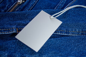 Blank price tag on jeans background