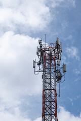 Close view of communication cell phone tower shot against blue sky. Technology, broadcast, telecommunication, data transmission and outage concept.