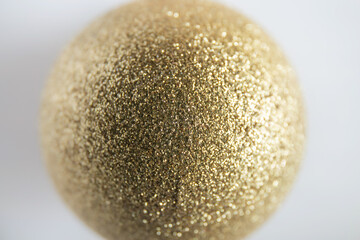 Shallow depth of field of gold glitter colored Christmas bauble. Christmas background concept.