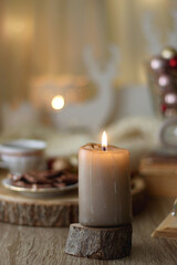 Cup of tea or coffee, various sweets and spices, Christmas decorations, comfy blanket, books and glasses. Selective focus.