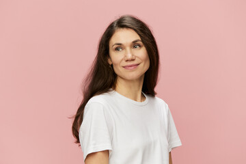 horizontal portrait of a cute attractive woman on a pink background in a clean white tank top smiling pleasantly at the camera