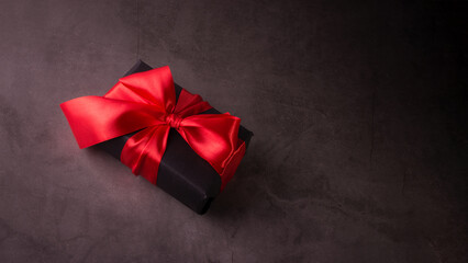 Black Friday Shopping Concept with Black gift box with red ribbon. Boxing day promo banner with copy space.