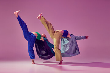 Way to future. Contemporary dance couple in motion and action isolated on crystal pink background....