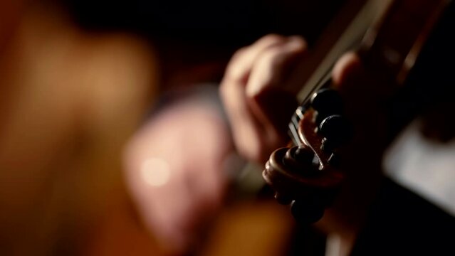 Close-up of a professional violinist playing classical music in an orchestra