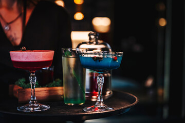 glasses alcohol cocktail set on a waiter tray in bar