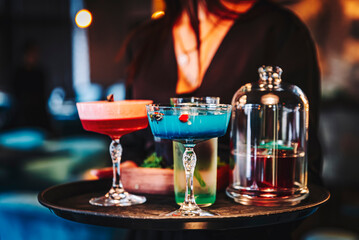 Fototapeta na wymiar glasses alcohol cocktail set on a waiter tray in bar
