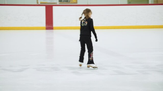 Little skater practicing her elements at the morning figure skating practice.