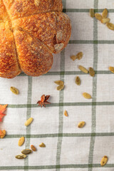 Craft pumpkin bread with pumpkin seeds . Homemade wholemeal rye yeast-free bread on a white striped towel
