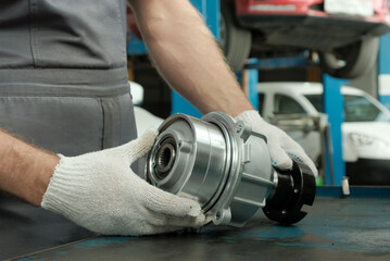 Spare parts for the car. Car service. All-wheel drive clutch. The car mechanic performs inspection...