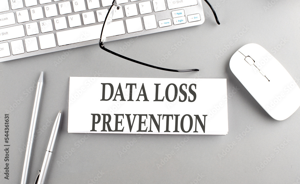 Aufkleber data loss prevention text on paper with keyboard on grey background